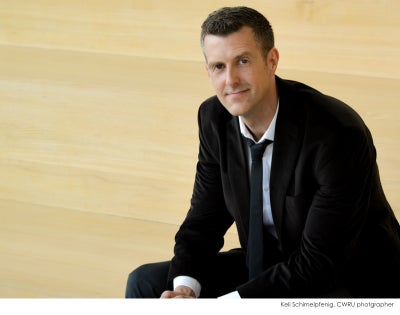 John Broich sitting on pale stairs