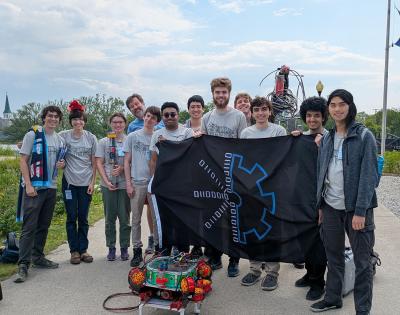 CWRUbotix team posing for a photo while holding their flag