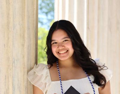 Elena Cangahuala holding her mortar board