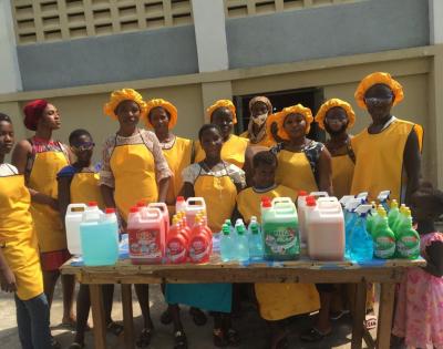 An image of a group of girls standing behind a table.