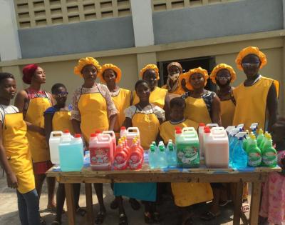An image of a group of girls standing behind a table.