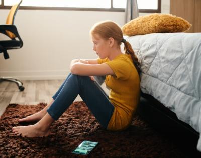 Child sitting on bedroom floor