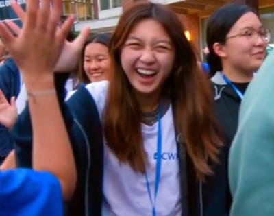 Student laughing in a crowd