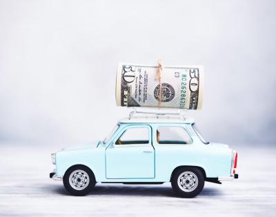 Small blue car with money on top