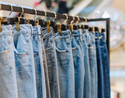 Denim jeans on a rack in a storefront