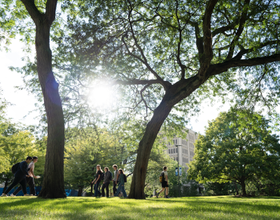Students walking on campus on a sunny day