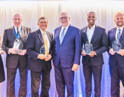 Five Case Western Reserve University alumni award winners pose with President Eric W. Kaler