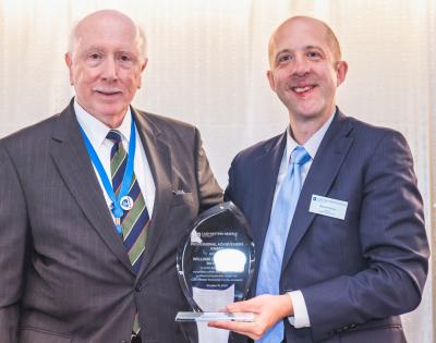 Case Western Reserve University alumni William Chiego and Nicholas Zalany pose with an alumni award