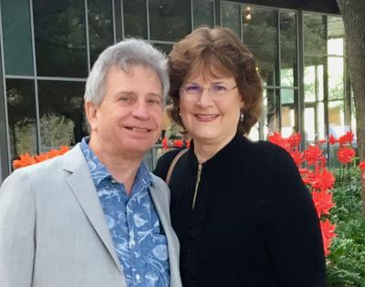 Ed and Joyce Lehotsky pictured together outside standing in front of flowers