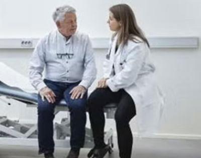Generic doctor's office image with male patient speaking with female doctor