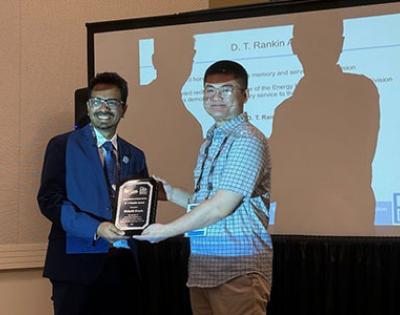 Photo of Rishab Kundu receiving an award