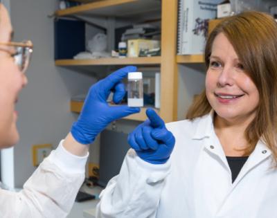 Agata Exner looking at materials in a lab with a student