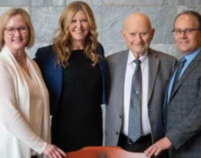 Left to right, standing in front of the named chair: Anne Templeton Zimmerman’s daughter, Renee Stirling, MD (MED '95); Eileen Anderson, EdD; Gail Zimmerman, PhD; and Renee Stirling’s husband, Cory Stirling, MD