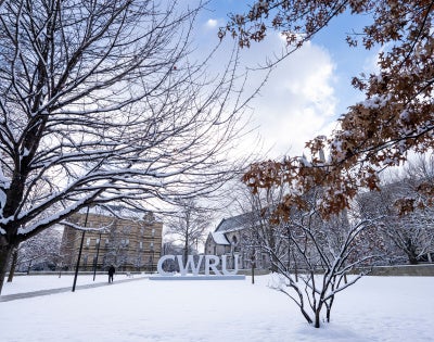 C-W-R-U letters sign covered in snow alongside the Binary Walkway.