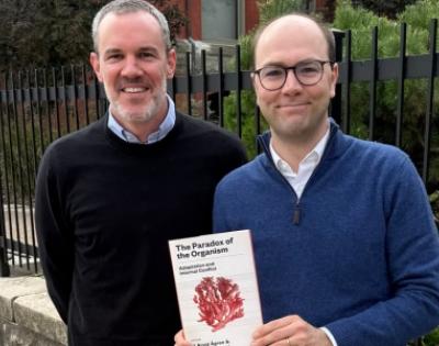 Co-editors J. Arvid Ågren and Manus M. Patten pose with their book, The Paradox of the Organism: Adaptation and Internal Conflict. 