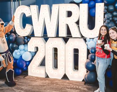 Photo of bicentennial signage and students