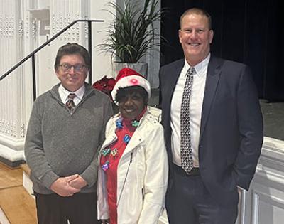 Fred Peck, Arlene Williams and Dean Tufts pose for a photo at the campus planning and facilities management holiday party