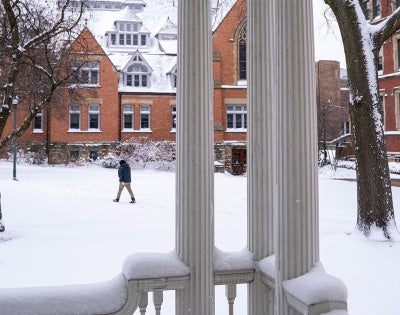 Photo of a person walking across Mather Quad on a snowy day on the CWRU campus