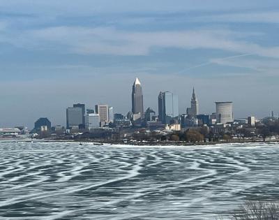 Photo of an icy Lake Erie with the Cleveland skyline in the background