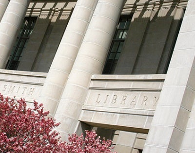 Kelvin Smith Library building in the springtime with a flowering tree
