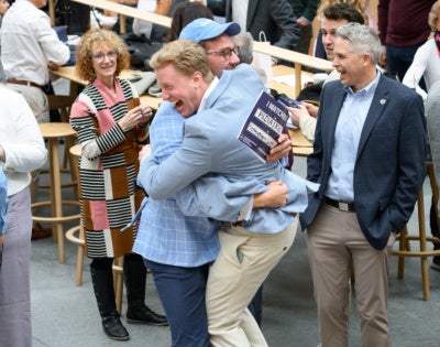 two students hugging as they open their match day envelopes