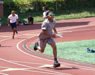 NYSP participants run on a track field