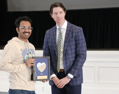 Image of Rishabh Kundu holding an award next to Tim Dengler
