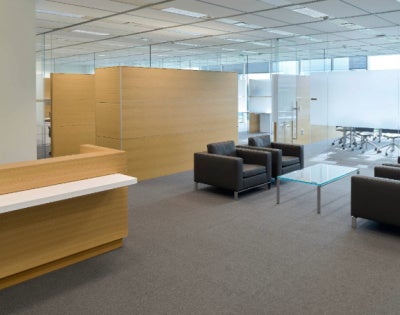 Marian K. Shaughnessy Nurse Leadership Academy lobby with brown desk and black couches.
