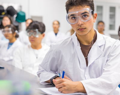 Image of a student taking notes in a lab