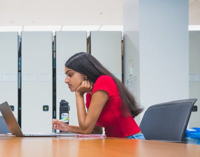 Two students work at a desk at Kelvin Smith Library