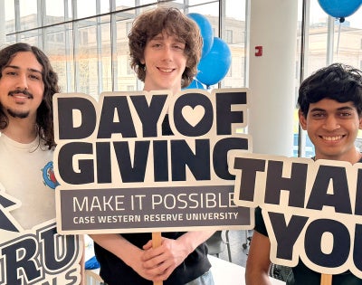 Students holding signs expressing thanks