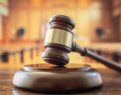 Judges gavel in court room legal trial and law background