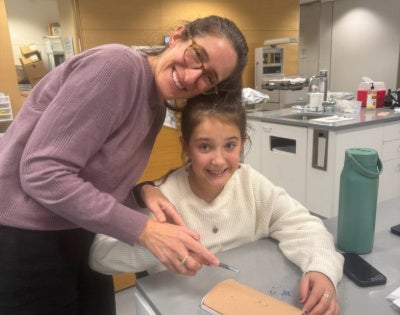 Hedy Leiter practices sutures with a child