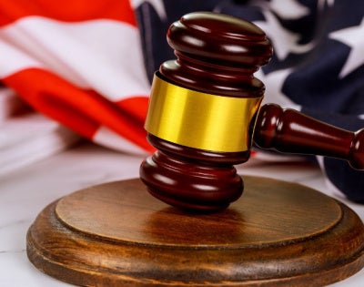 A gavel with a background of the American flag