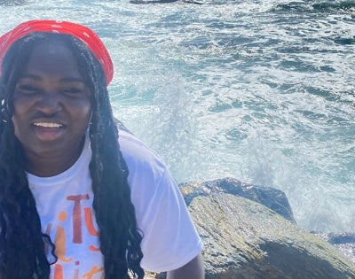 Ruth Boampong poses for a photo in front of a body of water