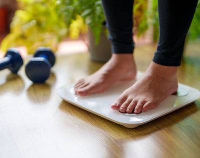 A close-up view of a woman standing on a weighing scale