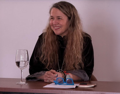 Damaris Puñales-Alpizar sitting at a table