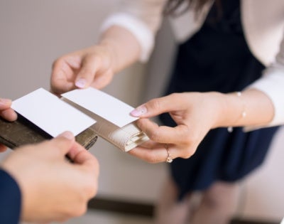 Close up of people exchanging business cards