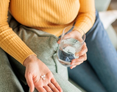 Close up of an unidentified person taking medication 