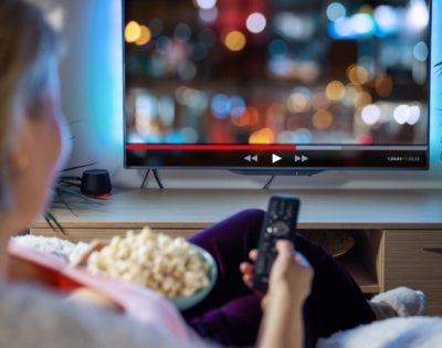 View of unidentified woman watching TV