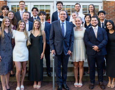 Group of students standing next to dean baur