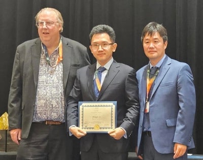 Chengyu Li takes a gropo photo after receiving the Fluids Engineering Division Summer Meeting Rising Star (FEDSM) Award.