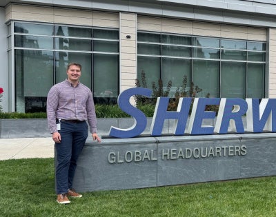 Connor Black standing in front of Sherwin-Williams signage