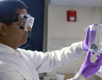 Professor Rohan Akolkar looking at a jar