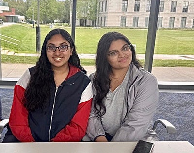 Aditi Bohre and Mahek Goel sit at a table in Tinkham Veale University Center