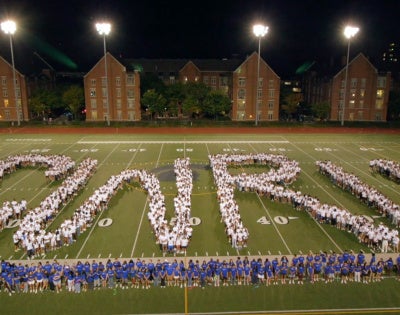 Photo of the Class of 2030 spelling out the CWRU letters on DiSanto Field