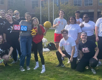 A group of students from Players' Theatre Group pose together on campus