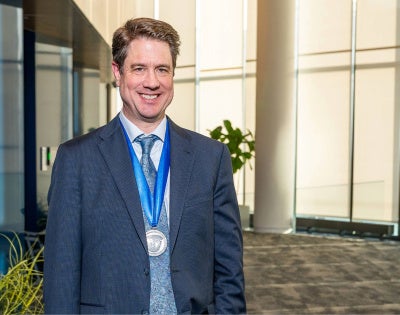 Andrew Pieper posing with the Case Medal around his neck
