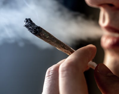 Image of a human smoking marijuana
