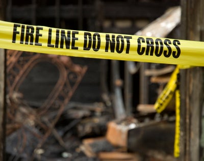 Image of yellow tapes at a fire scene